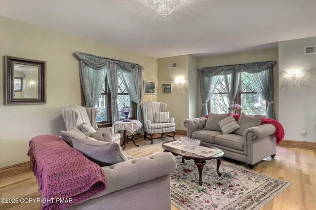 a view of a dining room with furniture and chandelier