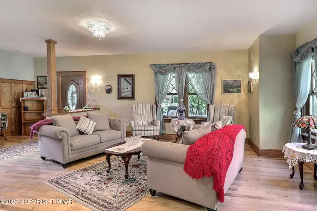 a view of a dining room with furniture and chandelier