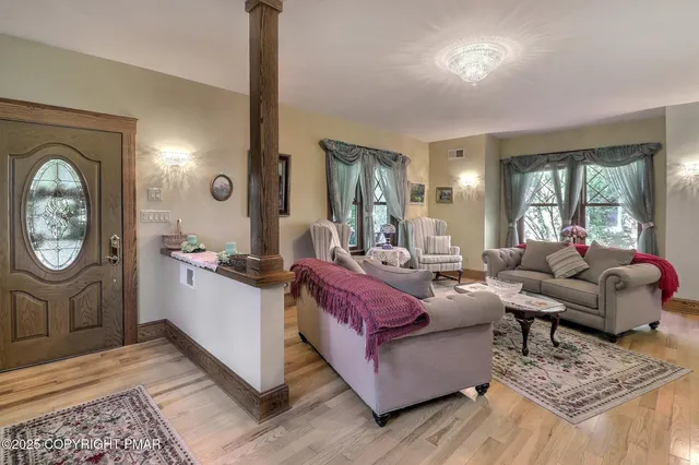 a kitchen with stainless steel appliances kitchen island granite countertop a sink refrigerator and cabinets