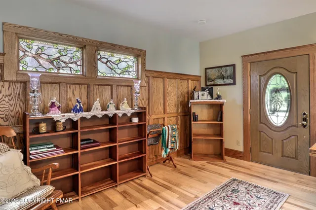 a kitchen with stainless steel appliances granite countertop a refrigerator a sink a stove top oven and a dining table with wooden floor