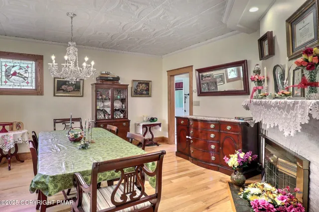 a living room with furniture a flat screen tv and a floor to ceiling window