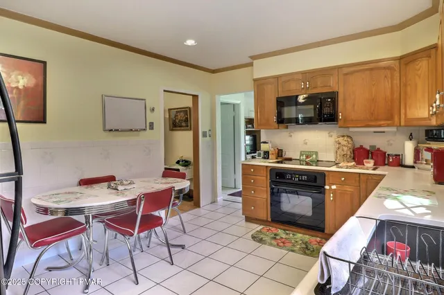 a bedroom with a bed and dresser with mirror