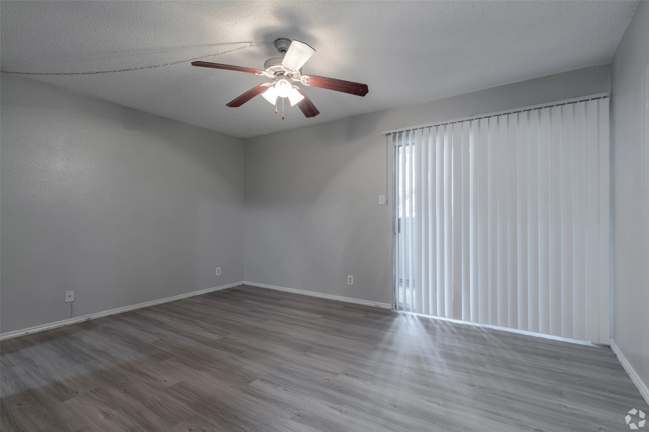 7610 Cameron Road, Unit 1011 Austin, TX 78752 - Photo 10 of 42 a view of an empty room with wooden floor and a window