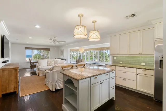 a kitchen with a refrigerator sink and cabinets