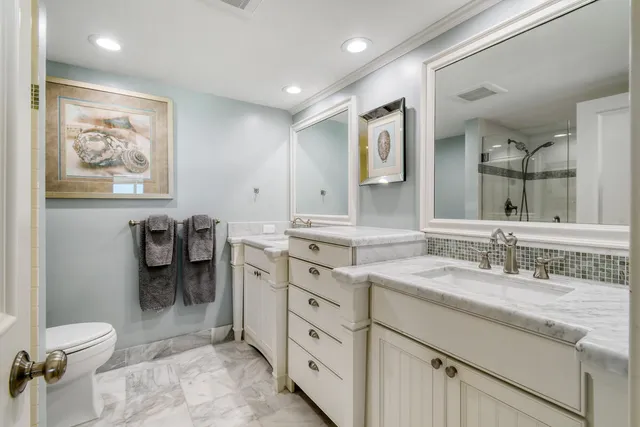 a view of a swimming pool and lounge chairs in back yard