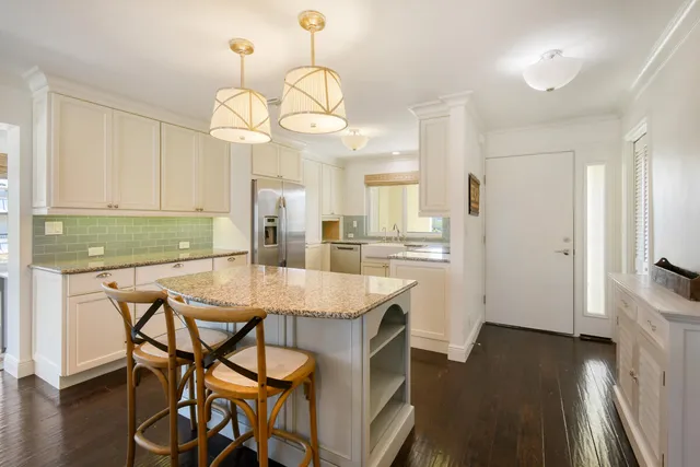 a kitchen with white cabinets and white appliances