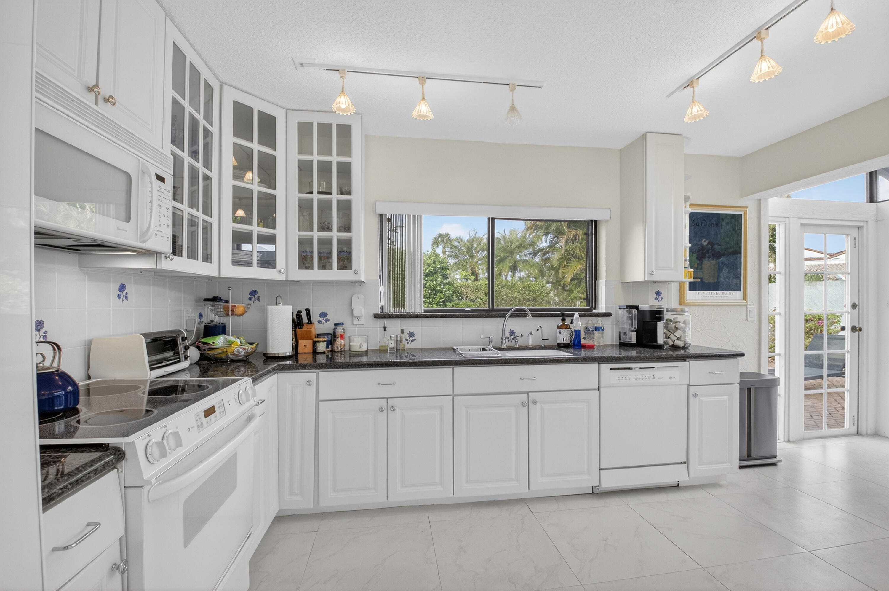 19629 Bay Cove Drive Boca Raton, FL 33434 - Photo 17 of 91 a kitchen with stainless steel appliances granite countertop a sink and cabinets