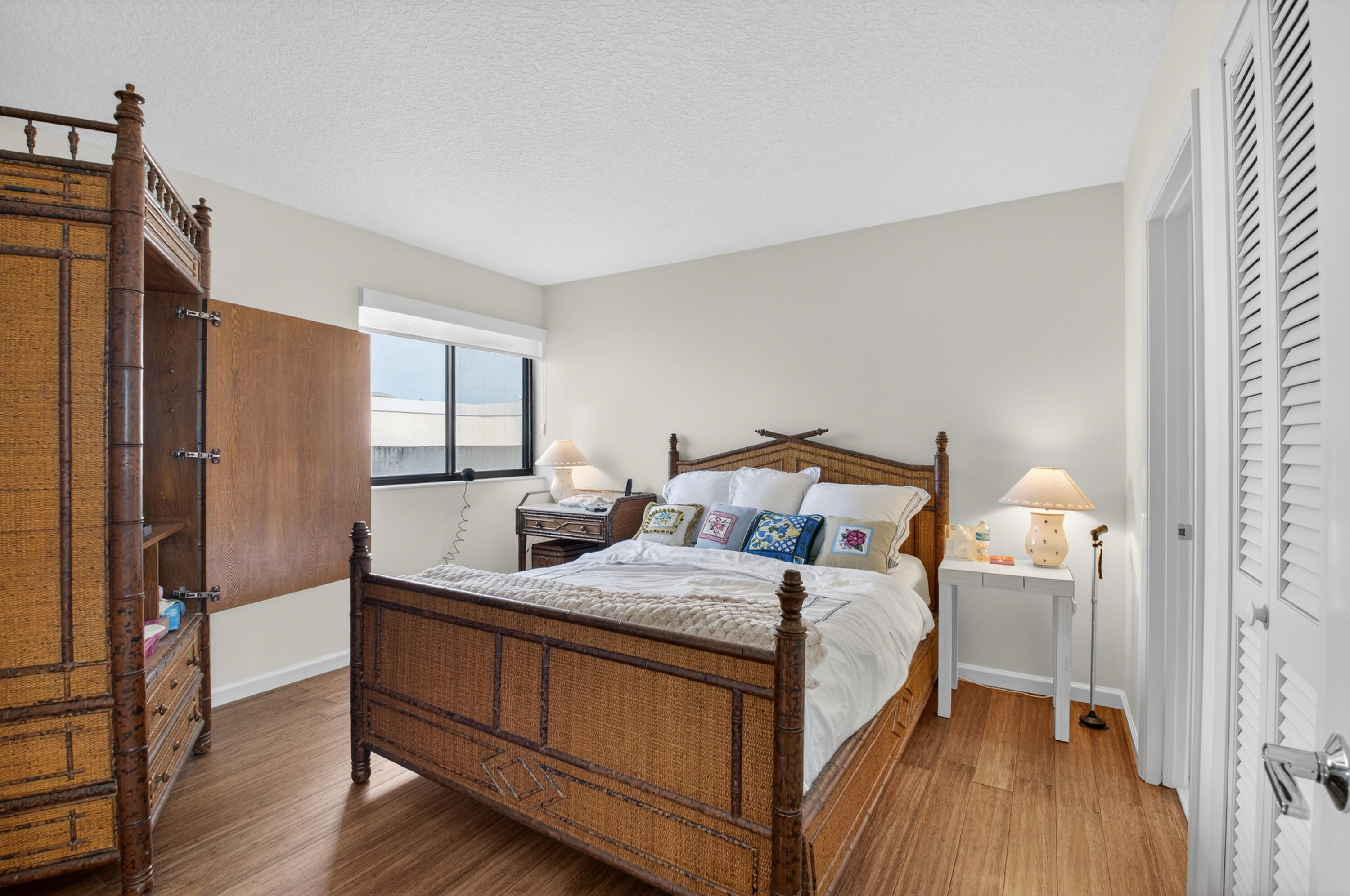 19629 Bay Cove Drive Boca Raton, FL 33434 - Photo 39 of 91 a bedroom with a bed and wooden floor