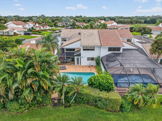 an aerial view of a house with a garden and lake view