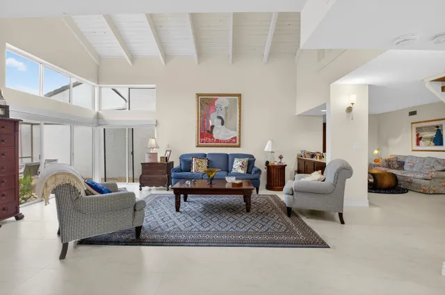 a spacious bathroom with a granite countertop sink a toilet a mirror and vanity