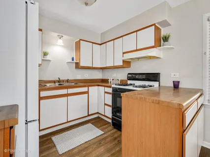 a kitchen with a cabinets and white appliances