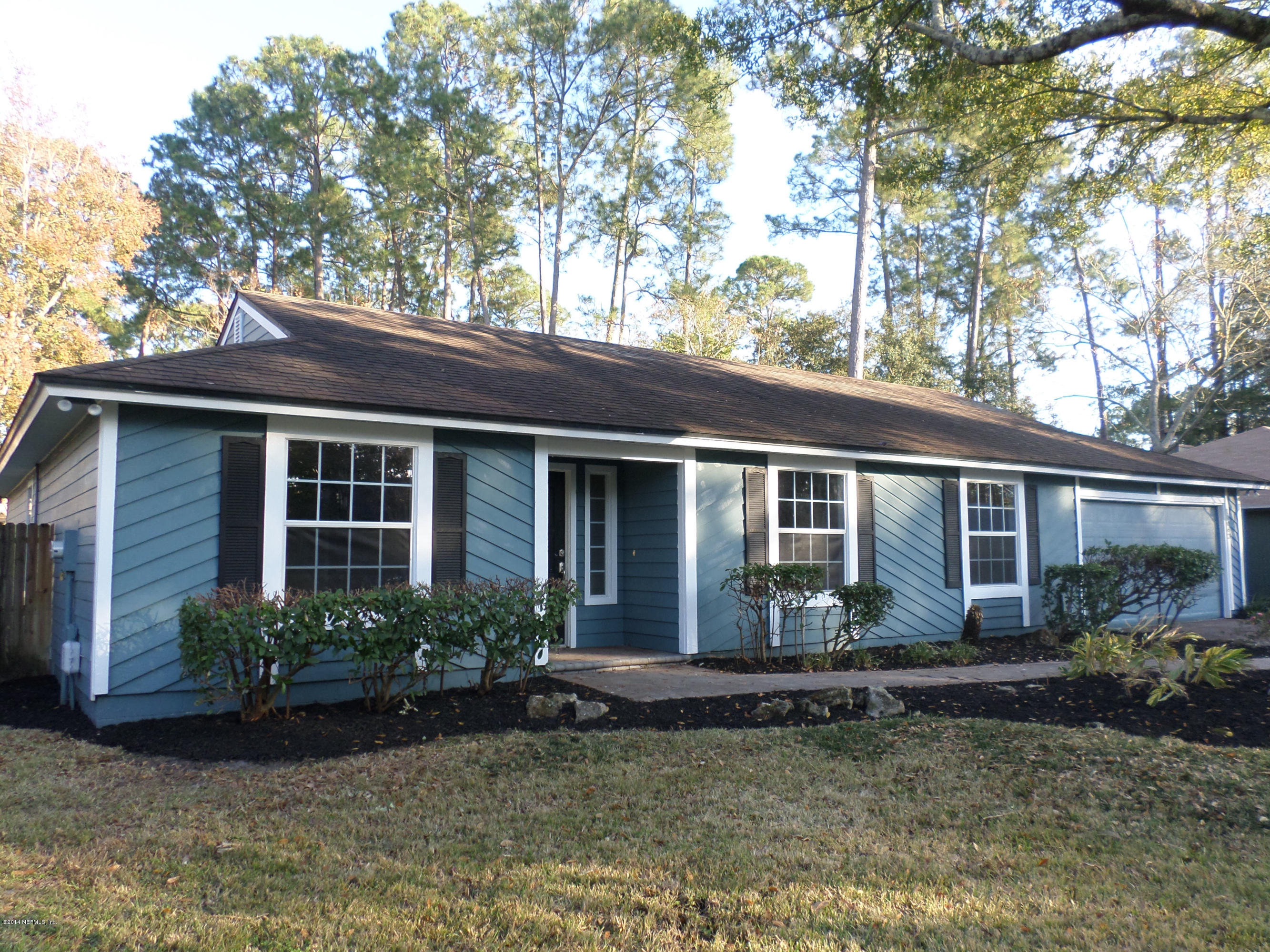 11063 Reading Road Jacksonville, FL 32257 - Photo 1 of 23 a view of a house with a yard plants and large tree
