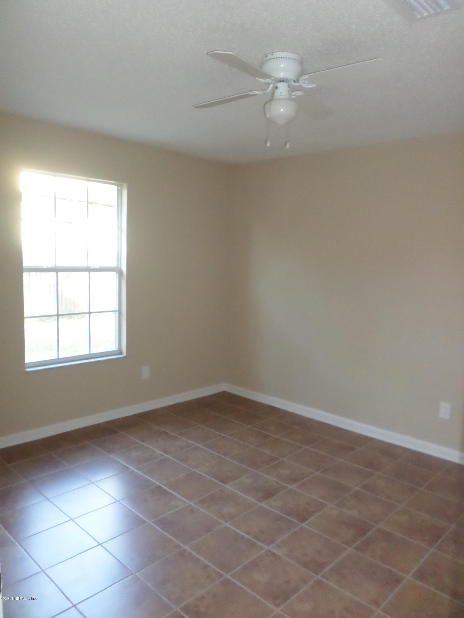 11063 Reading Road Jacksonville, FL 32257 - Photo 14 of 23 an empty room with a window and a fan