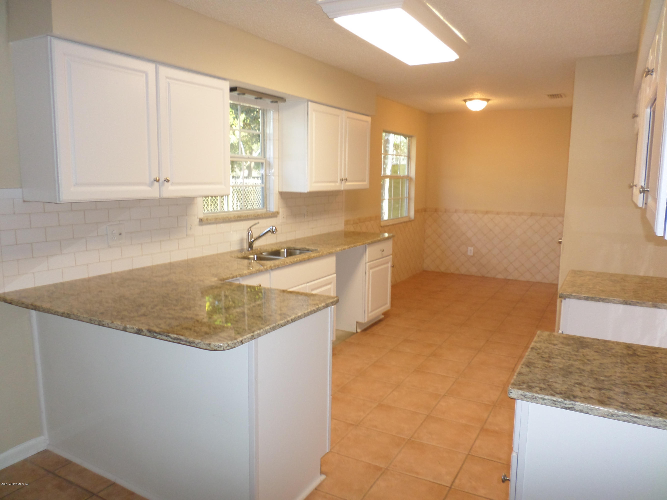 11063 Reading Road Jacksonville, FL 32257 - Photo 8 of 23 a kitchen with granite countertop a sink and a stove