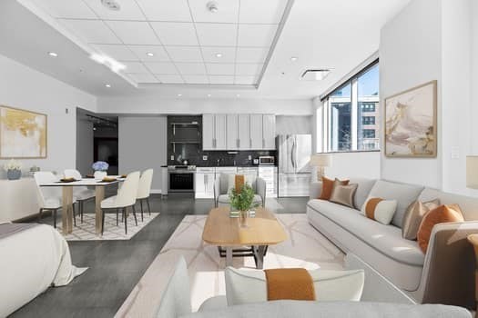a living room with furniture wooden floor and kitchen view