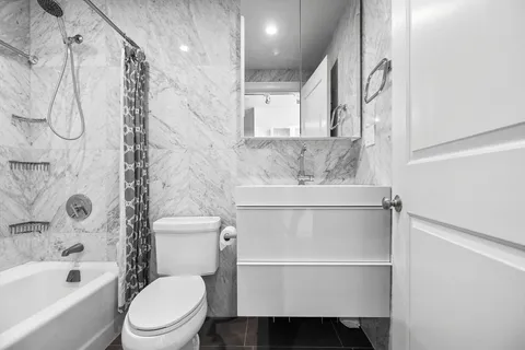a bathroom with a toilet sink and shower