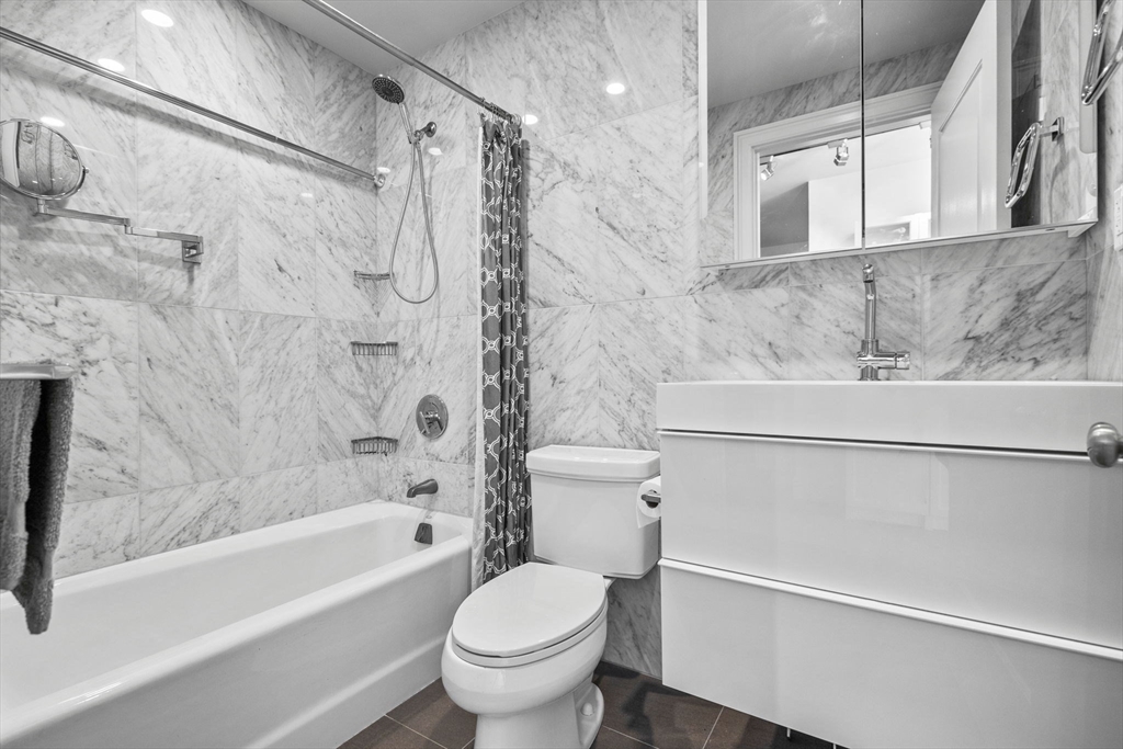 1 Charles Street South, Unit 210 Boston, MA 02116 - Photo 4 of 11 a bathroom with a sink toilet and shower