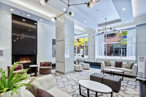 a living room with furniture and a chandelier