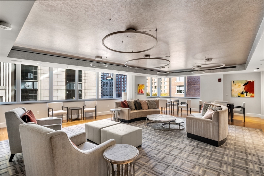1 Charles Street South, Unit 210 Boston, MA 02116 - Photo 9 of 11 a living room with furniture and a large window
