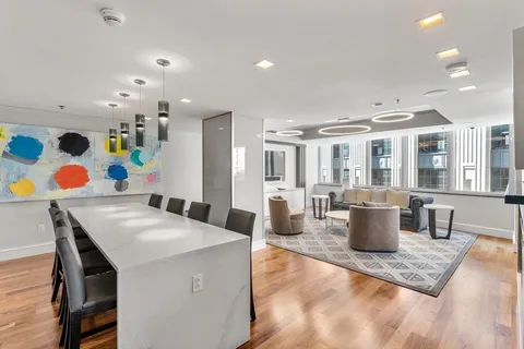 a living room with dining room and furniture