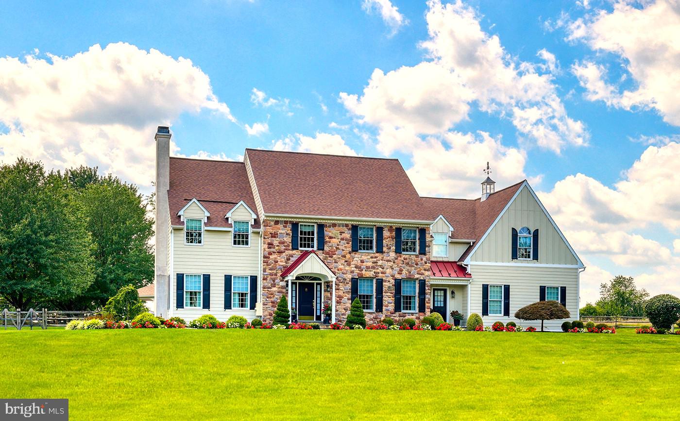 a front view of multiple houses with yard and green space