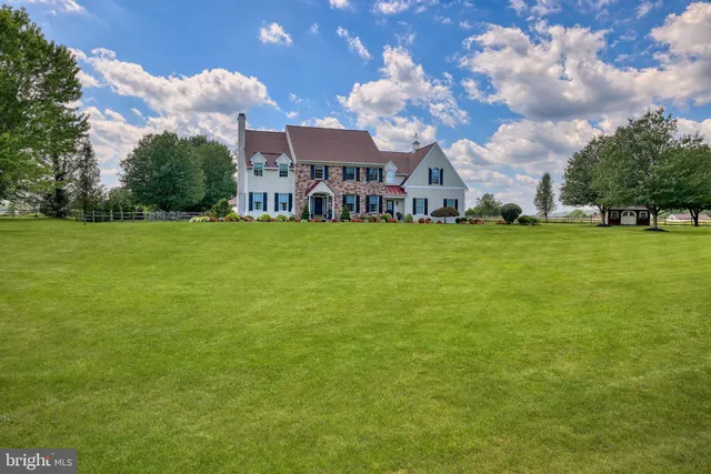 an aerial view of residential houses with outdoor space and trees