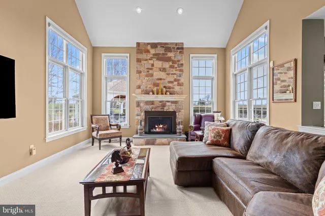 a dining room with furniture a chandelier and wooden floor