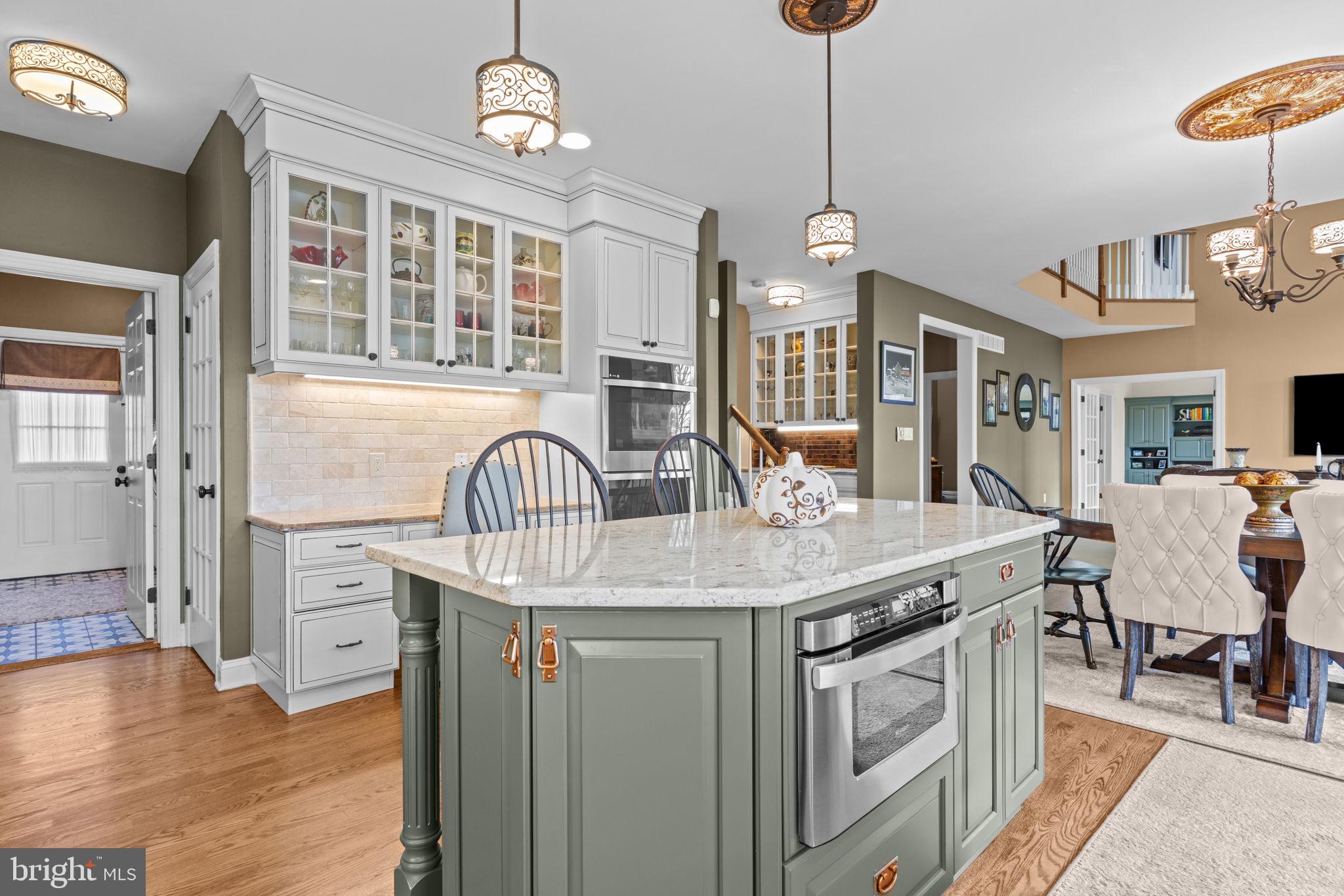 1100 Pineville Road New Hope, PA 18938 - Photo 20 of 97 a kitchen with stainless steel appliances granite countertop a kitchen island a stove and a wooden floors