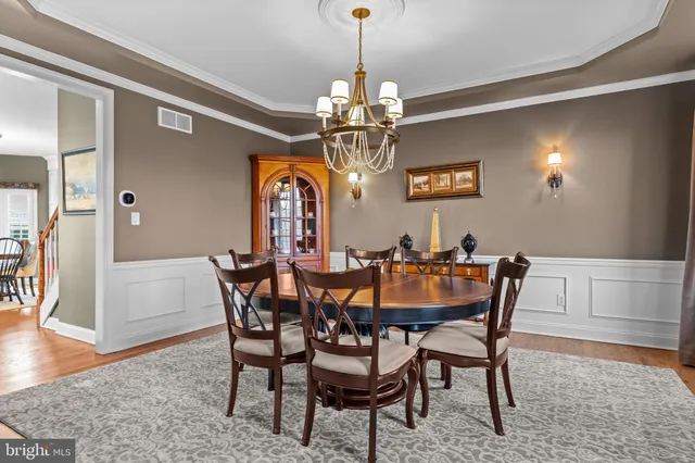 a bedroom with two beds and a book shelf