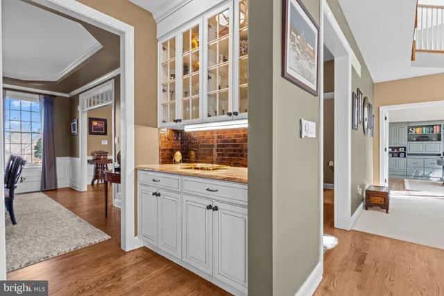 a spacious bathroom with a granite countertop sink and a mirror