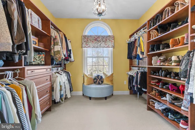 a spacious bedroom with a bed and ceiling fan