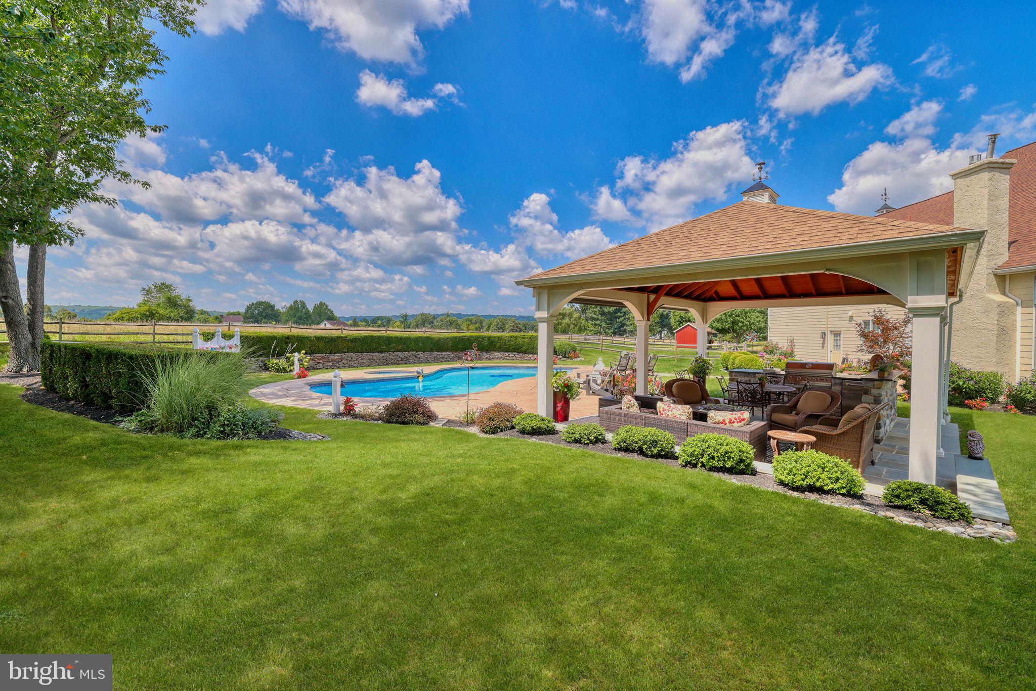 1100 Pineville Road New Hope, PA 18938 - Photo 68 of 97 a view of a garden with a bench under an umbrella