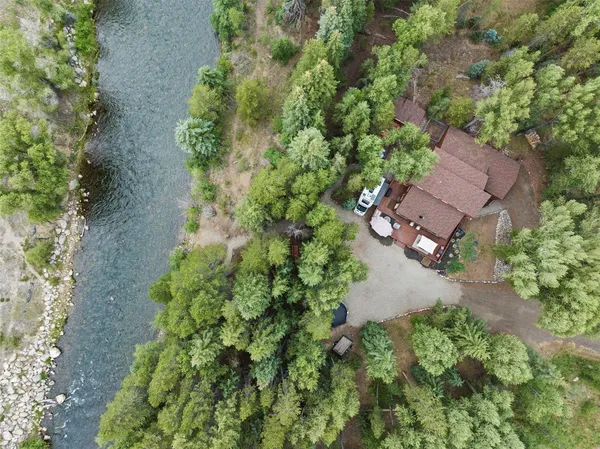 an aerial view of a house with a yard
