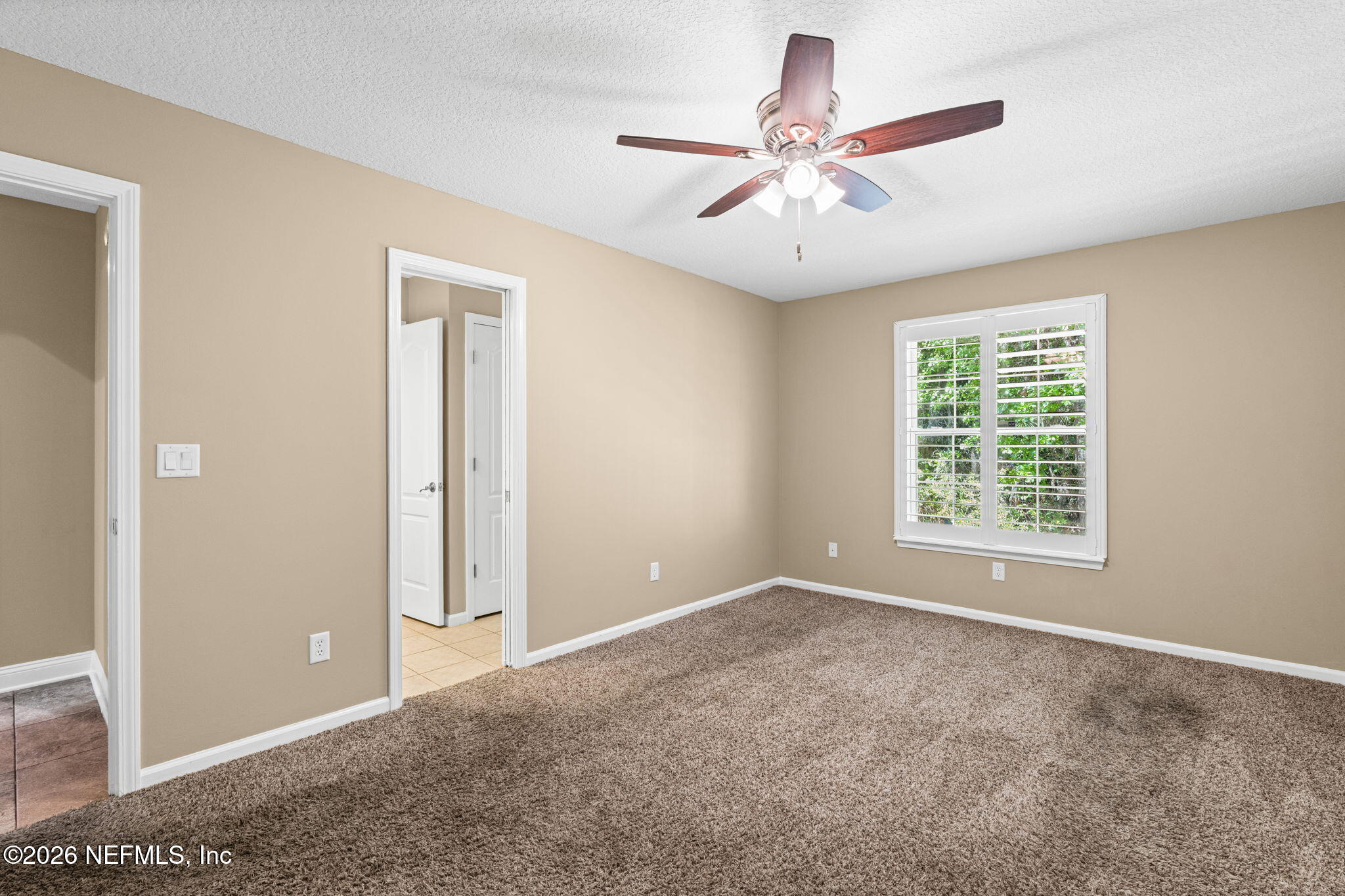 1600 Spring Water Court Fleming Island, FL 32003 - Photo 42 of 85 a view of a livingroom with a ceiling fan and window