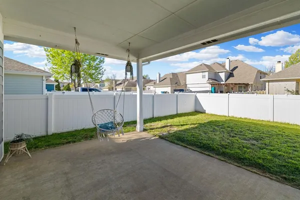 a view of a house with a yard and potted plants