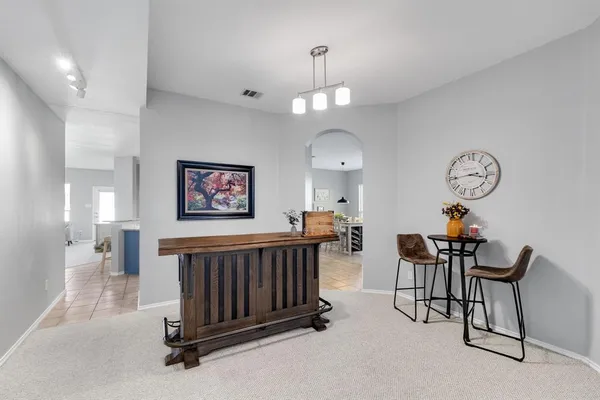 a living room with furniture a clock and a chandelier