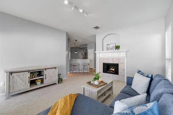 a living room with furniture and a fireplace
