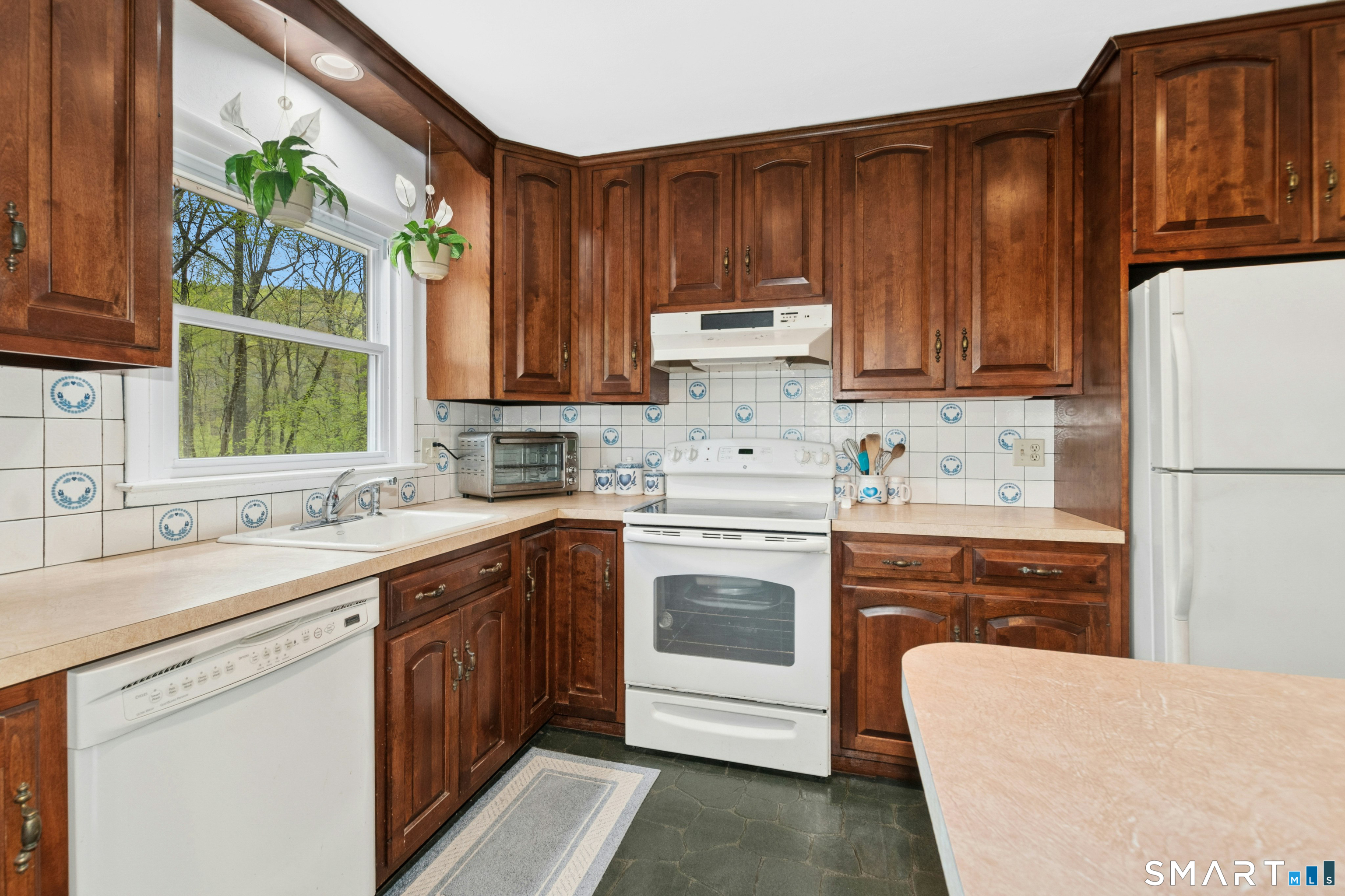 15 Limestone Terrace Ridgefield, CT 06877 - Photo 9 of 32 a kitchen with a sink stove and refrigerator