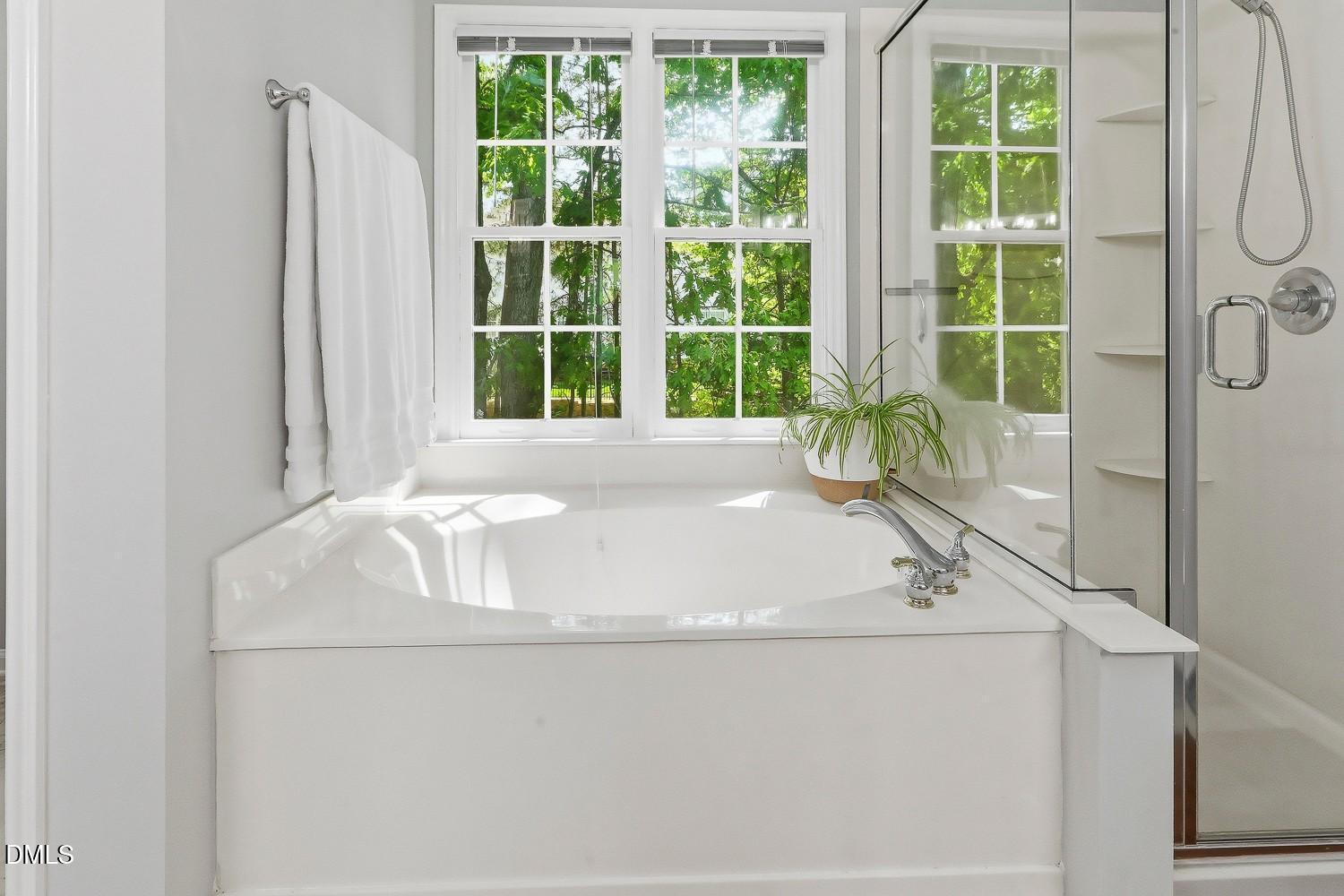 4001 Batiste Road Raleigh, NC 27613 - Photo 33 of 63 a white bath tub sitting in a bathroom next to a window