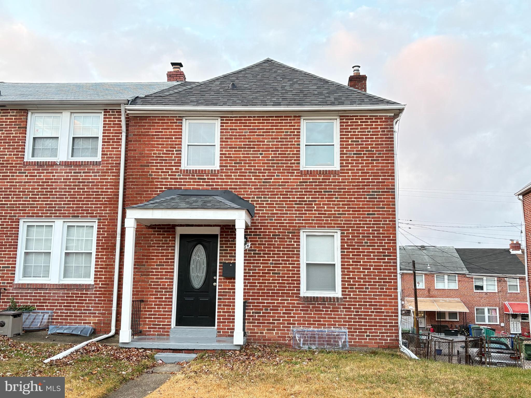 a front view of a house with yard and balcony