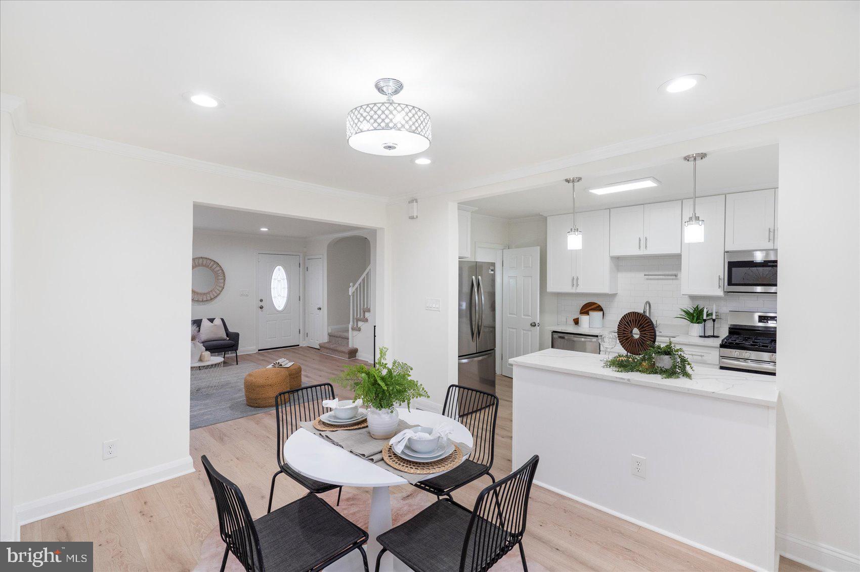 1324 Winston Avenue Baltimore, MD 21239 - Photo 11 of 33 a dining room with kitchen island furniture a chandelier and kitchen view
