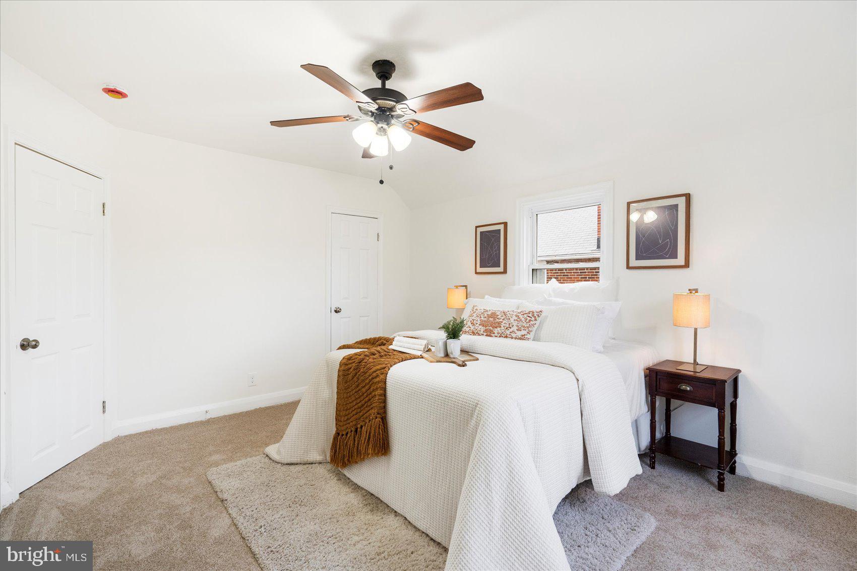 1324 Winston Avenue Baltimore, MD 21239 - Photo 18 of 33 a bedroom with a bed and a chandelier