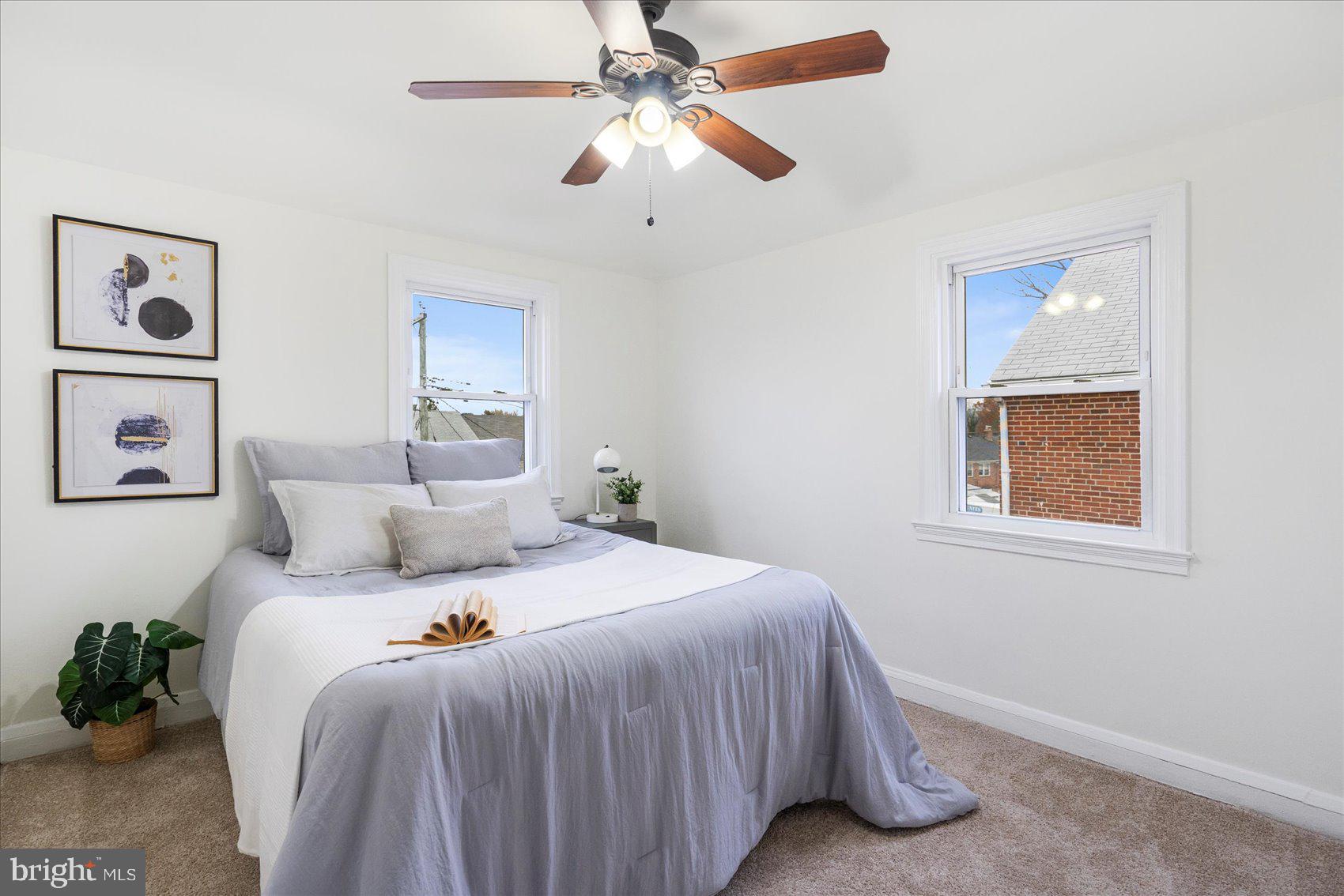 1324 Winston Avenue Baltimore, MD 21239 - Photo 19 of 33 a bedroom with a bed and a chandelier