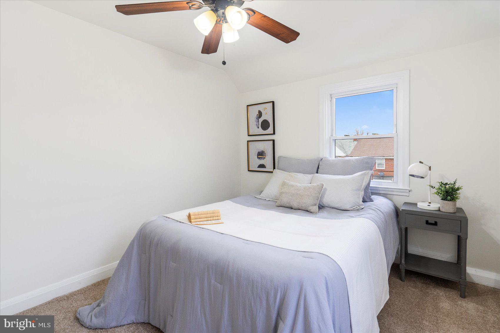 1324 Winston Avenue Baltimore, MD 21239 - Photo 20 of 33 a bedroom with a bed and a chandelier