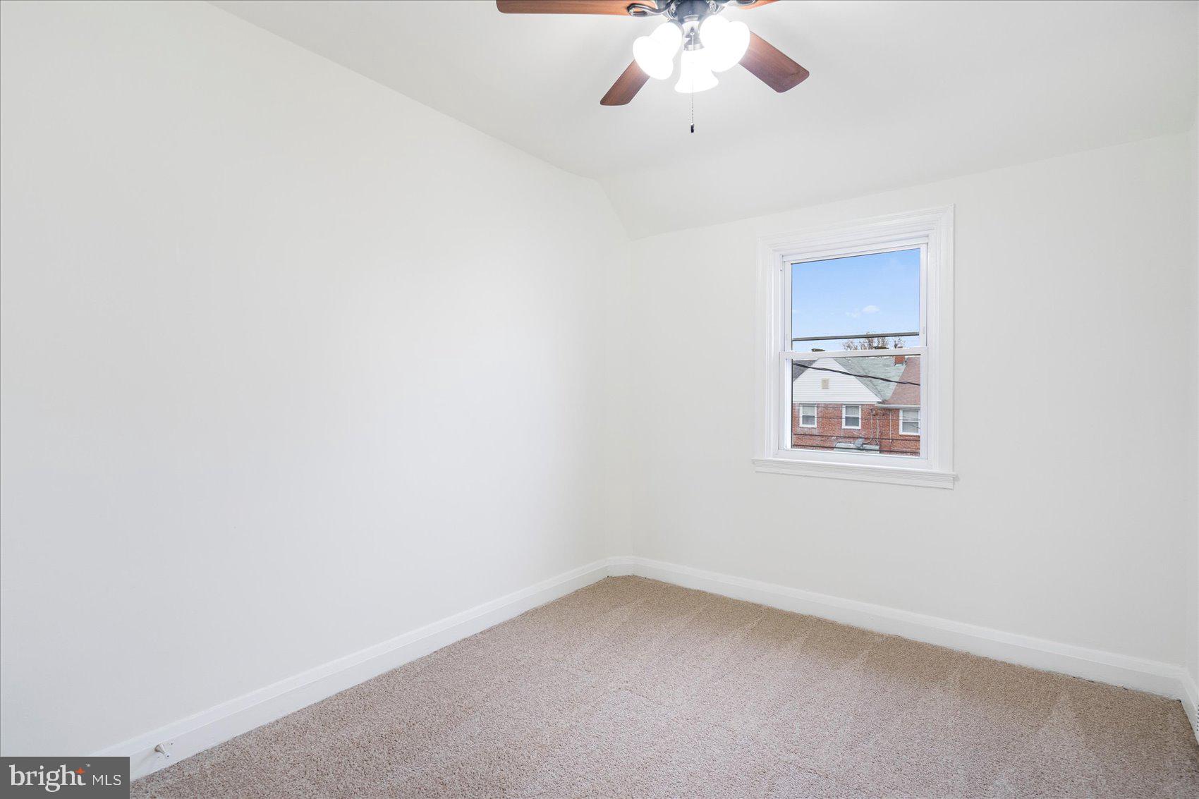 1324 Winston Avenue Baltimore, MD 21239 - Photo 21 of 33 an empty room with a chandelier fan