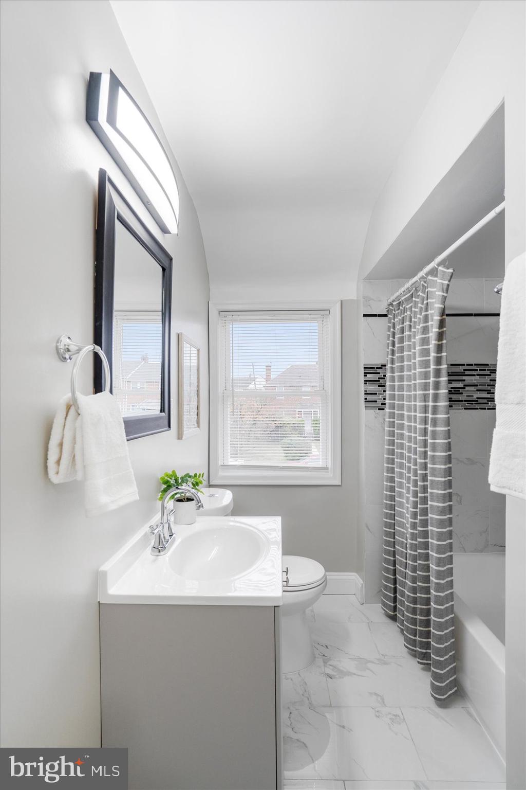 1324 Winston Avenue Baltimore, MD 21239 - Photo 24 of 33 a bathroom with a sink a toilet and mirror