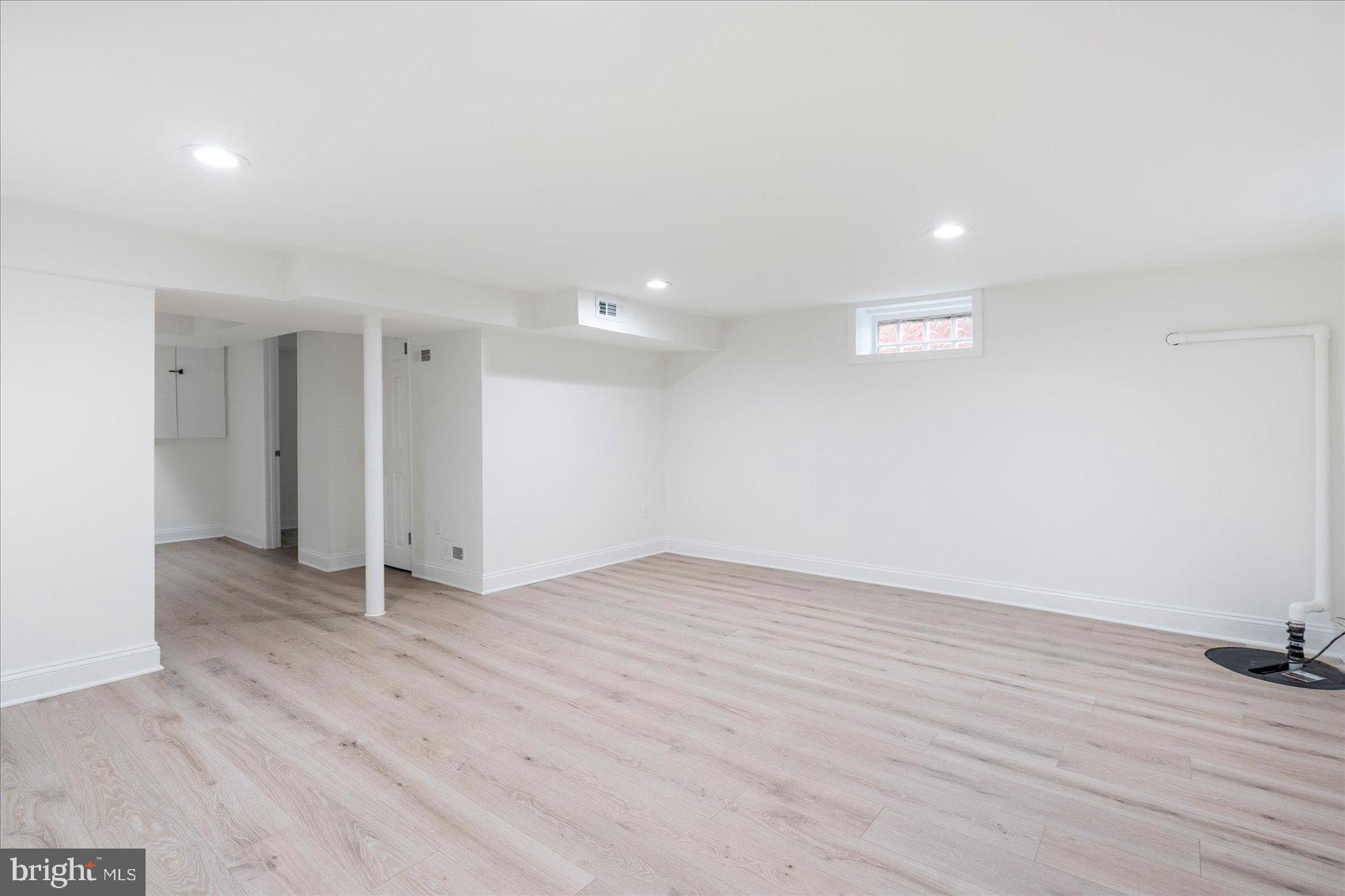 1324 Winston Avenue Baltimore, MD 21239 - Photo 26 of 33 an empty room with wooden floor