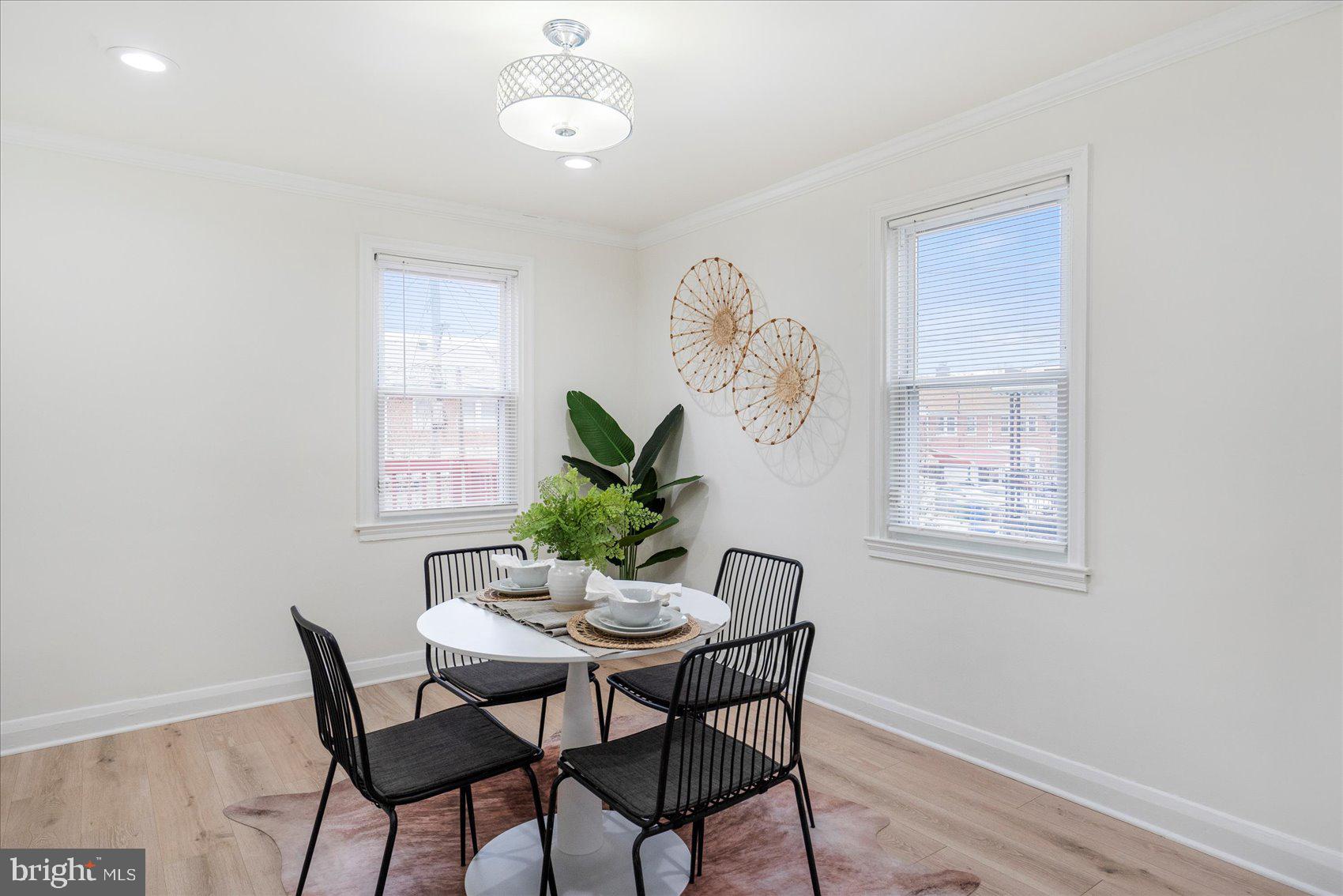 1324 Winston Avenue Baltimore, MD 21239 - Photo 8 of 33 a dining room with furniture a potted plant and a chandelier