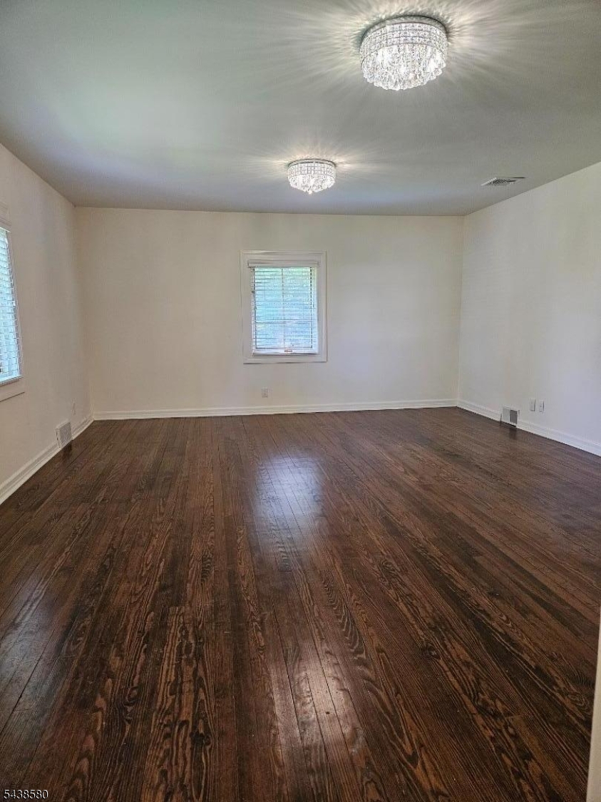 218 Devon Road Essex Fells, NJ 07021 - Photo 18 of 24 an empty room with wooden floor and windows