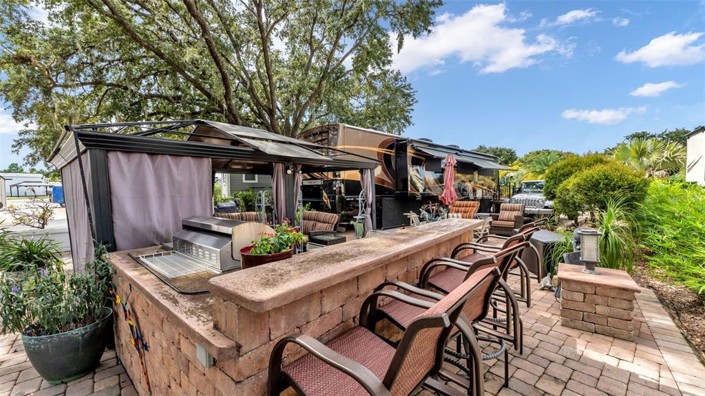 16357 Cherry Tree Court Clermont, FL 34714 - Photo 11 of 27 a view of a patio with table and chairs and potted plants